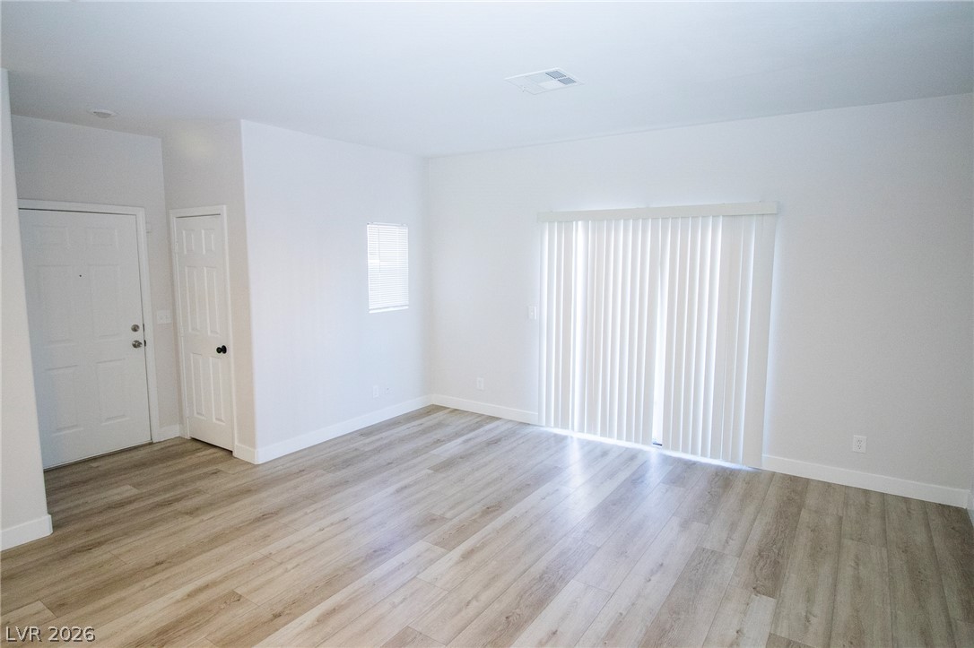 1468 Reef Ridge Court Las Vegas, NV 89128 - Photo 8 of 22 Naturally illuminated, this room features light-toned flooring and white walls, offering a clean, airy ambiance.