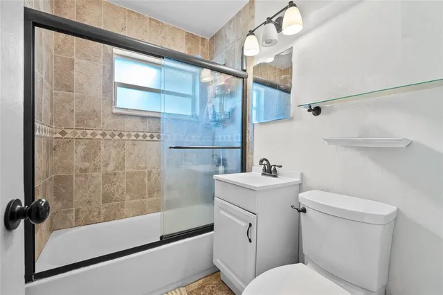 a spacious bedroom with a bed and a chandelier