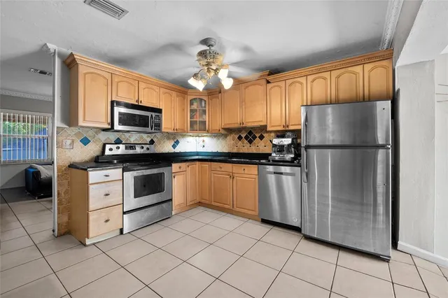 a kitchen with stainless steel appliances granite countertop a stove and a sink