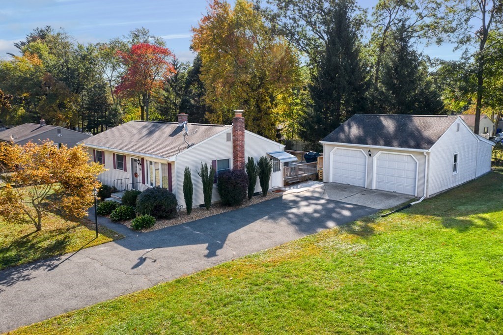 a view of a house with a yard and sitting area