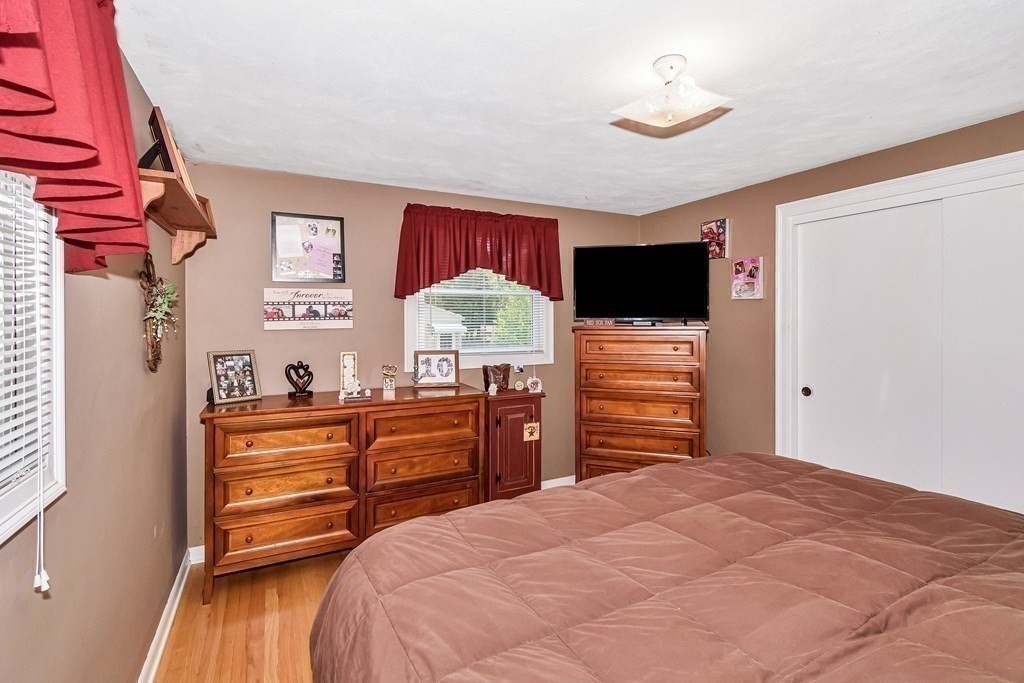 59 Corey Road Springfield, MA 01128 - Photo 11 of 22 a bedroom with a bed and a flat screen tv