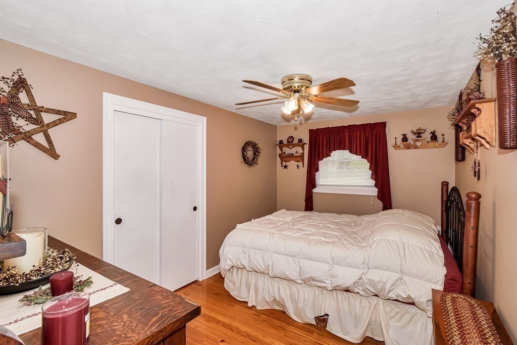 59 Corey Road Springfield, MA 01128 - Photo 9 of 22 a bedroom with a bed and a chandelier