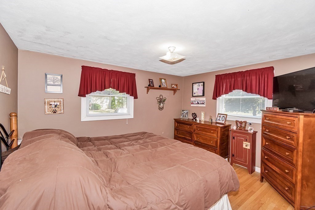 59 Corey Road Springfield, MA 01128 - Photo 10 of 22 a bedroom with a bed and dresser with mirror