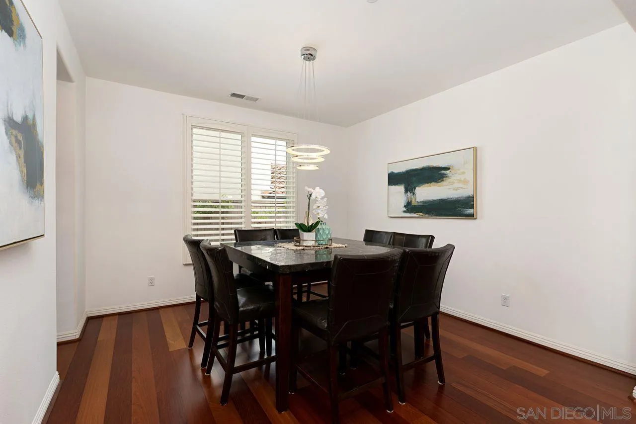 16076 Cayenne Ridge Road San Diego, CA 92127 - Photo 11 of 43 a view of a dining room with furniture window and wooden floor