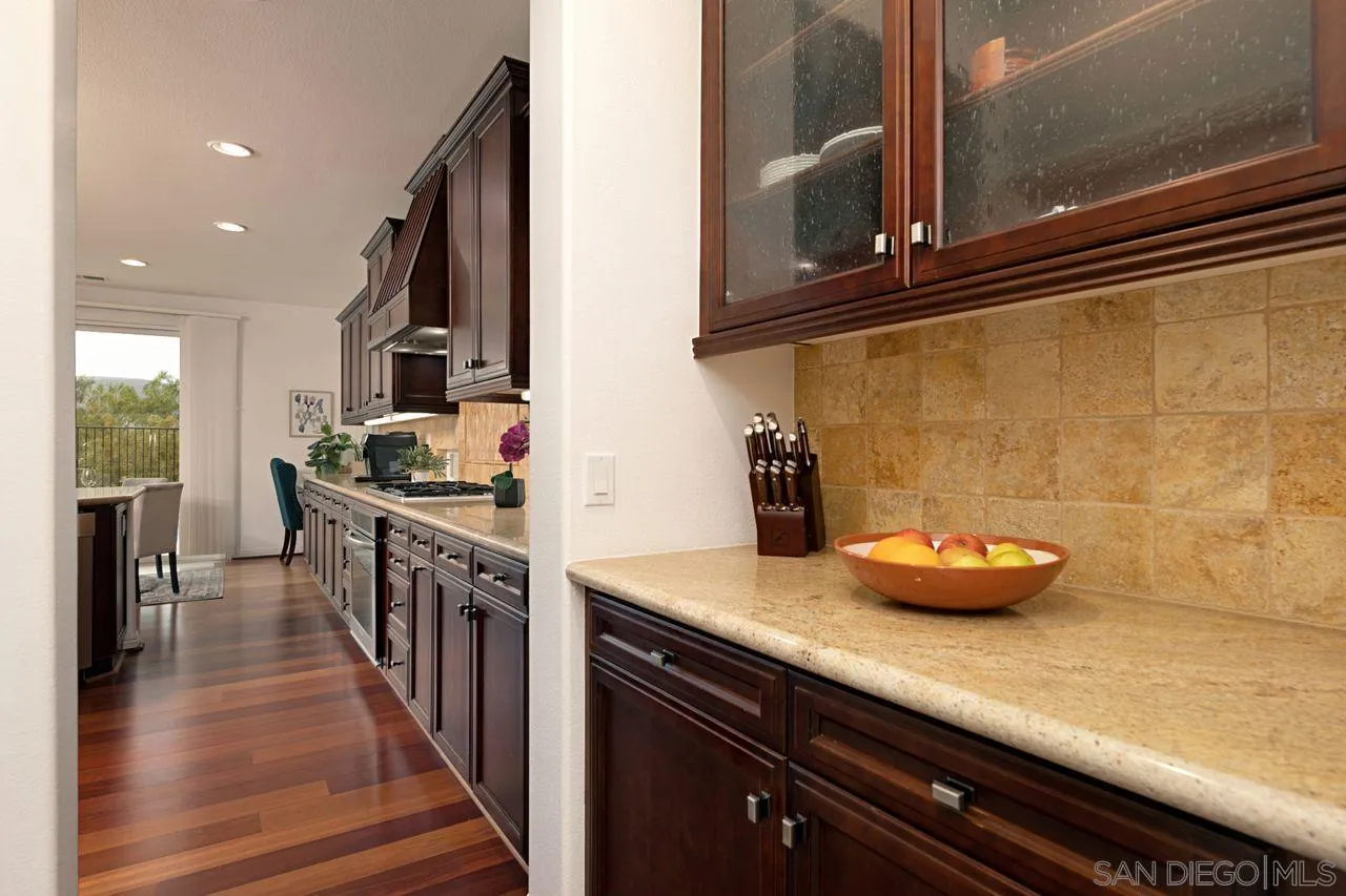 16076 Cayenne Ridge Road San Diego, CA 92127 - Photo 13 of 43 a kitchen with stainless steel appliances granite countertop a sink and cabinets