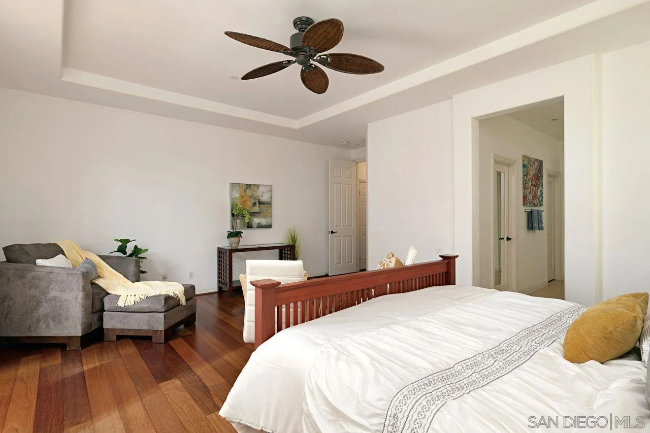 16076 Cayenne Ridge Road San Diego, CA 92127 - Photo 20 of 43 a bedroom with a bed and wooden floor