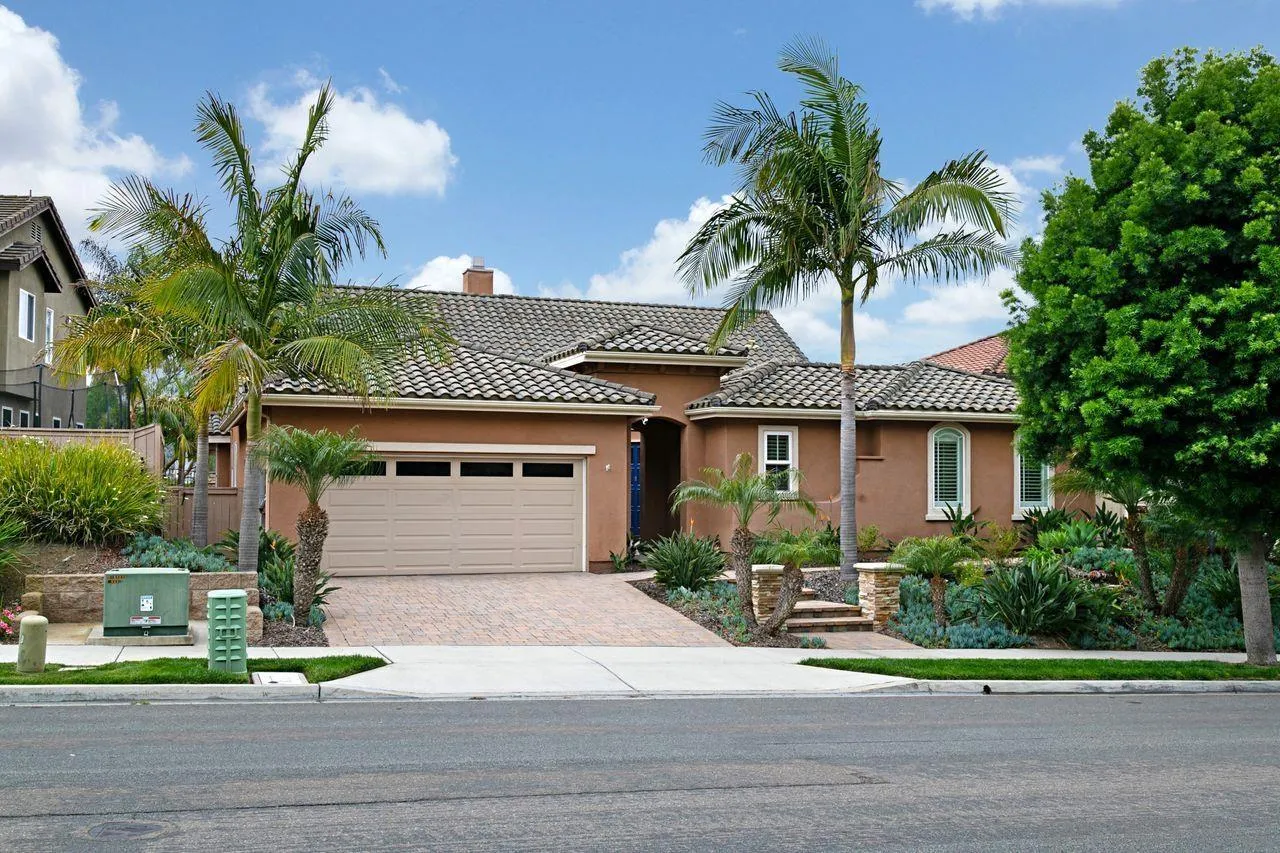 16076 Cayenne Ridge Road San Diego, CA 92127 - Photo 2 of 43 a front view of a house with garden