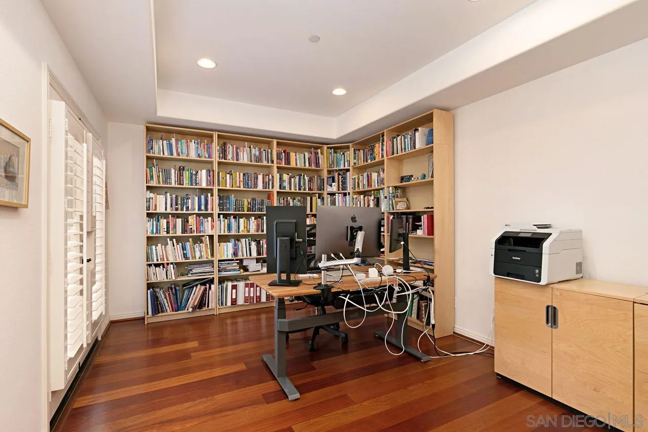 16076 Cayenne Ridge Road San Diego, CA 92127 - Photo 23 of 43 a view of a workspace with furniture and a book shelf