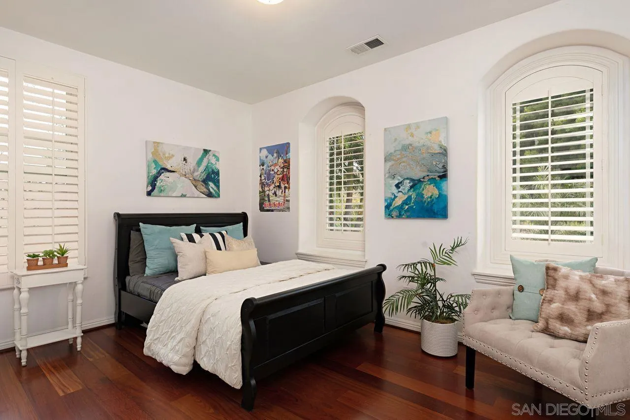 16076 Cayenne Ridge Road San Diego, CA 92127 - Photo 25 of 43 a bedroom with a bed and wooden floor