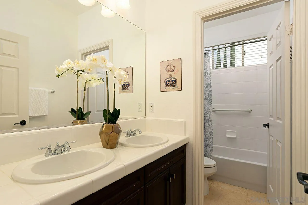 16076 Cayenne Ridge Road San Diego, CA 92127 - Photo 29 of 43 a bathroom with a granite countertop sink a toilet and shower