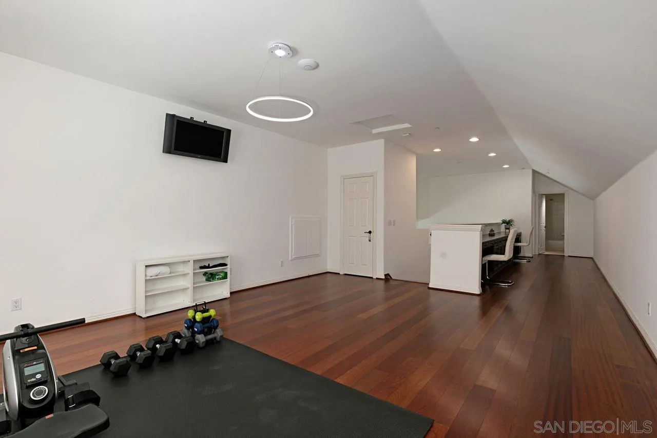 16076 Cayenne Ridge Road San Diego, CA 92127 - Photo 30 of 43 a room with furniture and a wooden floor