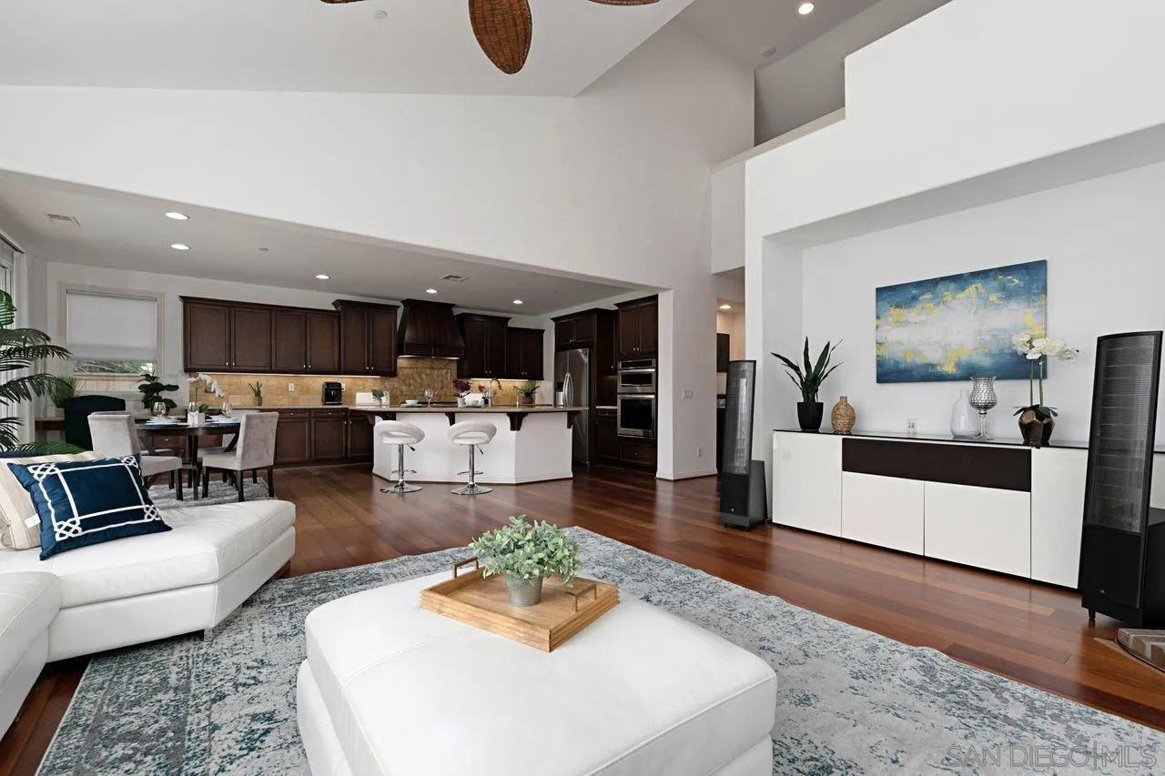 16076 Cayenne Ridge Road San Diego, CA 92127 - Photo 3 of 43 a living room with furniture kitchen view and a wooden floor