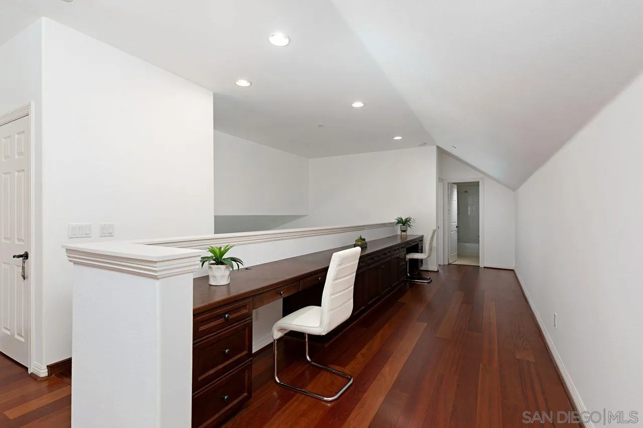 16076 Cayenne Ridge Road San Diego, CA 92127 - Photo 31 of 43 a hallway with furniture and wooden floor