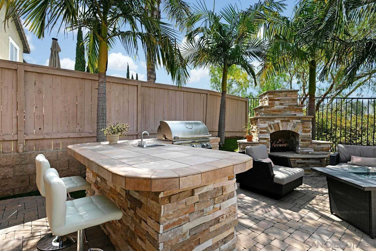 16076 Cayenne Ridge Road San Diego, CA 92127 - Photo 37 of 43 a view of a backyard with furniture and a fire pit