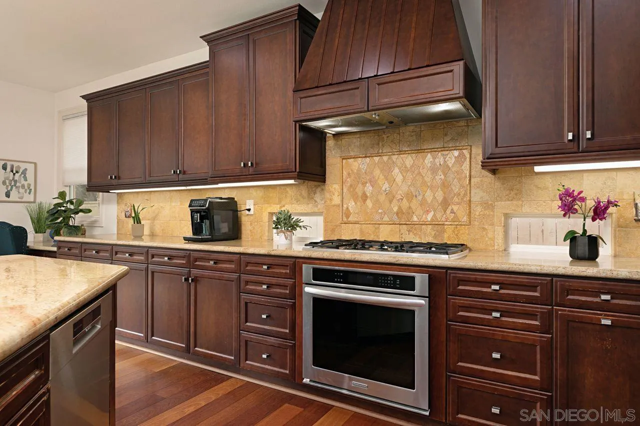 16076 Cayenne Ridge Road San Diego, CA 92127 - Photo 4 of 43 a kitchen with a stove and a sink