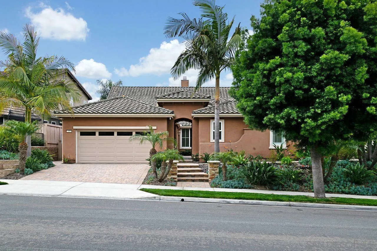16076 Cayenne Ridge Road San Diego, CA 92127 - Photo 43 of 43 a front view of a house with a garden and trees