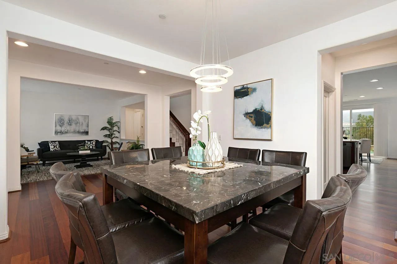 16076 Cayenne Ridge Road San Diego, CA 92127 - Photo 10 of 43 a view of a dining room with furniture and wooden floor