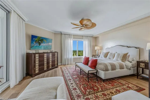 a spacious bedroom with a bed a window and walk in closet