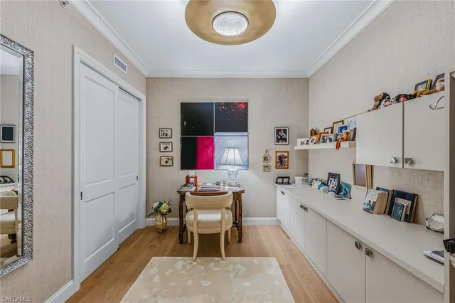 a room with furniture a flat screen tv and kitchen view