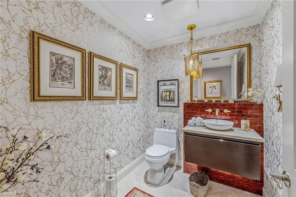 a bathroom with a toilet a sink and mirror