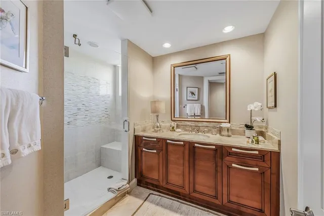 a bathroom with a double vanity sink mirror and toilet