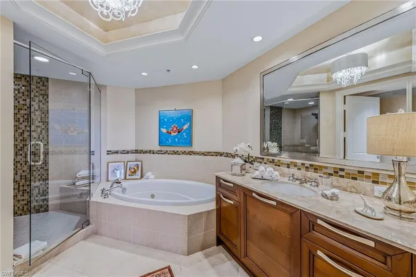 a bathroom with a granite countertop sink mirror and bathtub