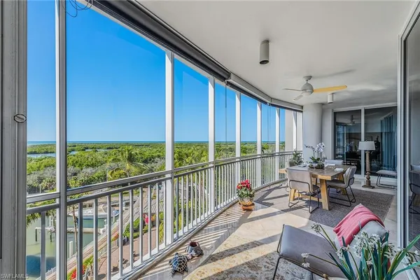 a view of a patio with chairs and potted plants