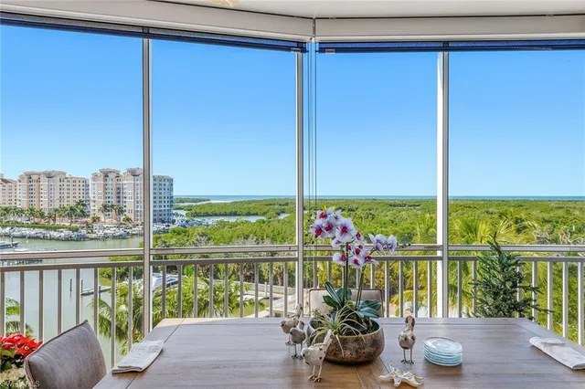 a view of a balcony with chairs and a potted plant
