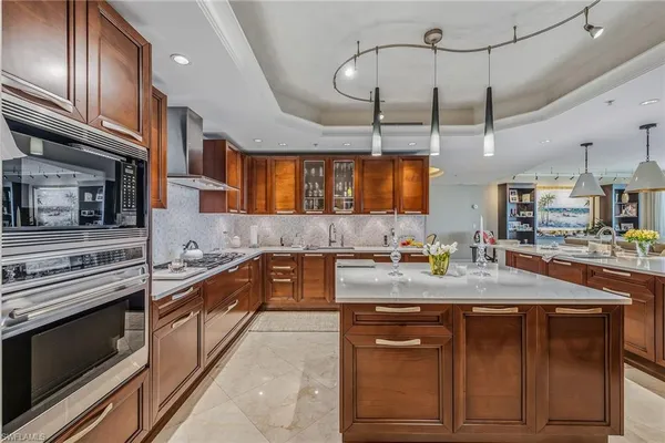 a kitchen with a stove a sink and cabinets