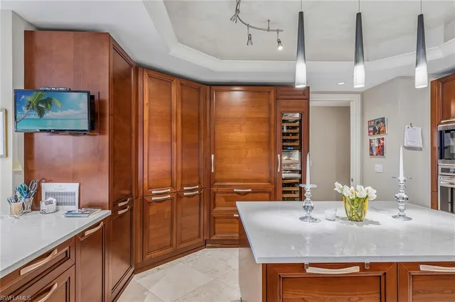 a kitchen with stainless steel appliances granite countertop a sink refrigerator and microwave