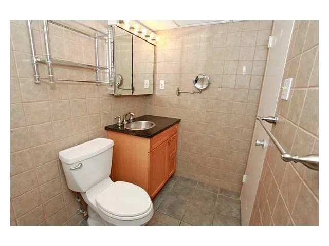 a bathroom with a toilet a sink and a shower