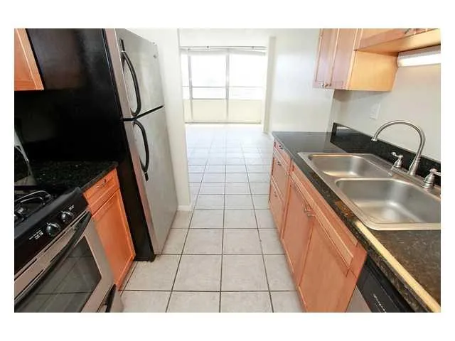 a kitchen with stainless steel appliances a sink stove and refrigerator