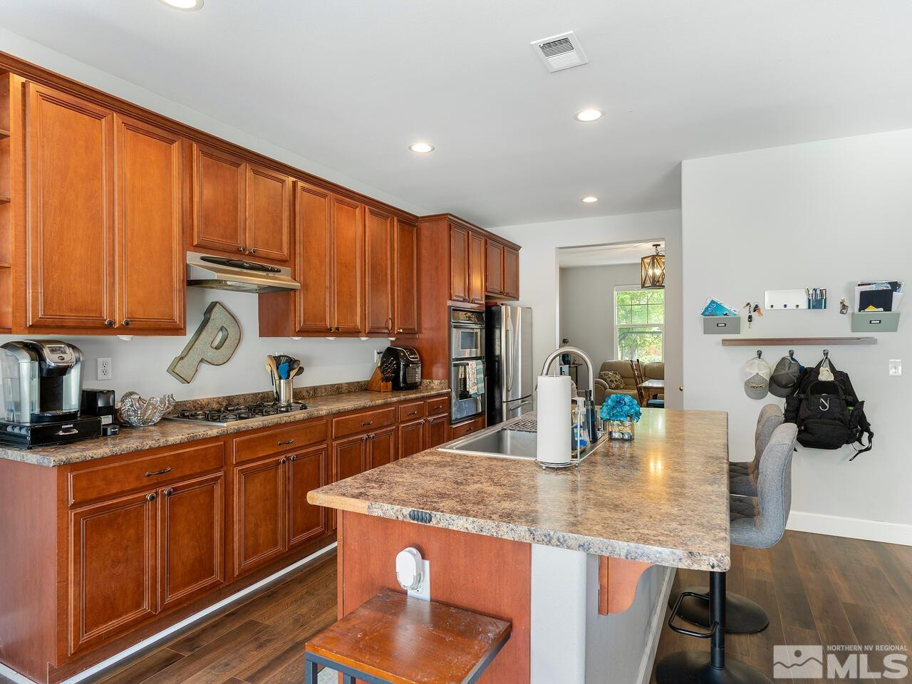 10805 Dancing Aspen Drive Reno, NV 89521 - Photo 13 of 25 a kitchen with stainless steel appliances granite countertop counter space a sink and cabinets