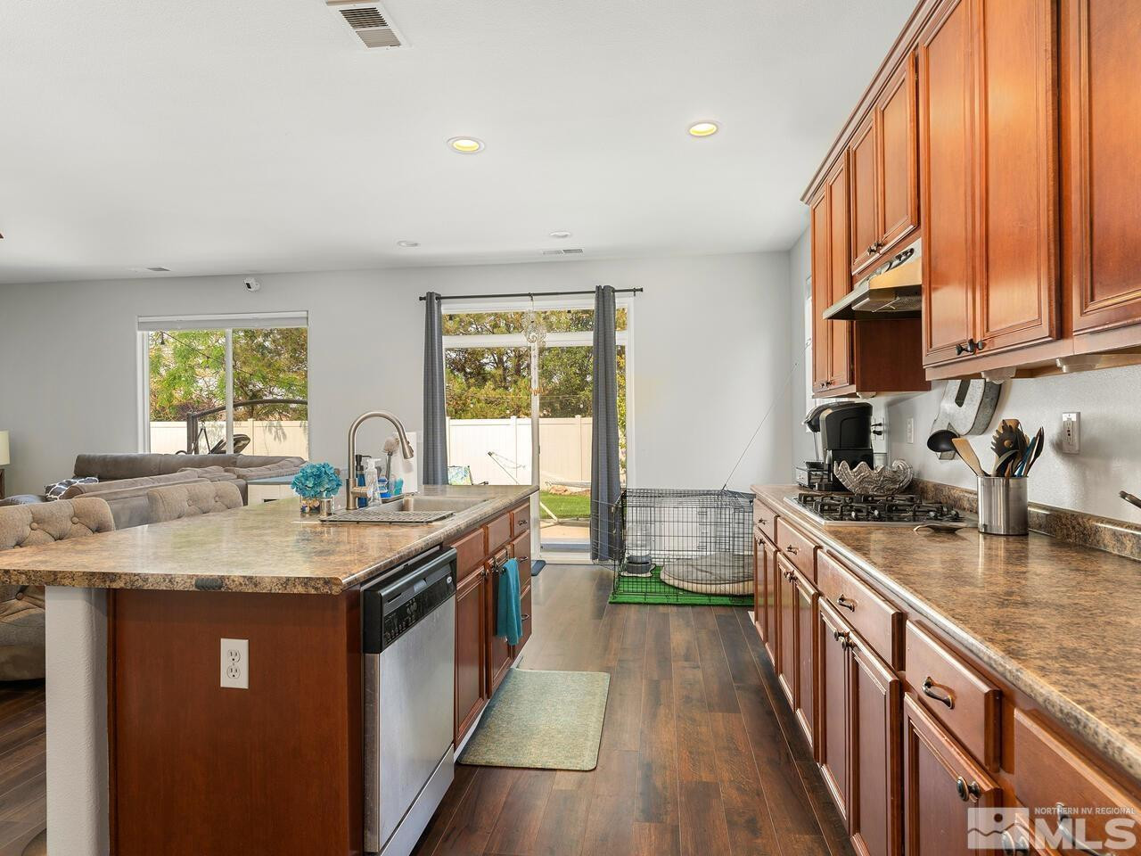 10805 Dancing Aspen Drive Reno, NV 89521 - Photo 14 of 25 a kitchen with a sink stove and cabinets