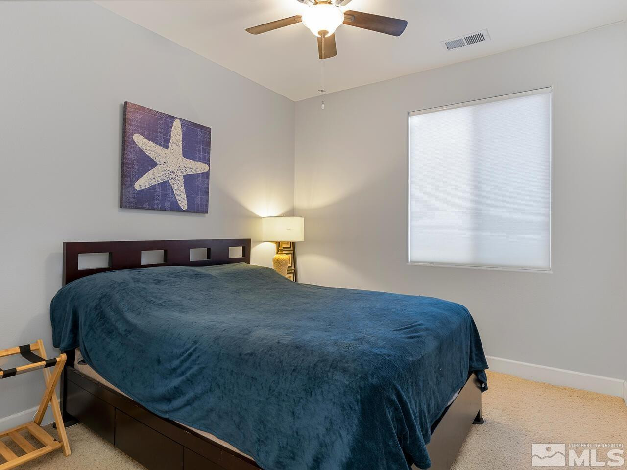 10805 Dancing Aspen Drive Reno, NV 89521 - Photo 18 of 25 a bedroom with a bed and a chandelier