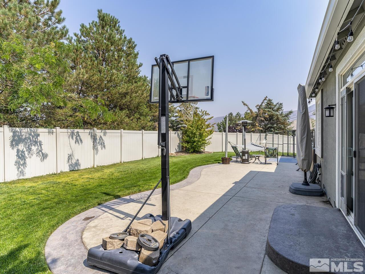 10805 Dancing Aspen Drive Reno, NV 89521 - Photo 21 of 25 a view of a back yard with a house and a garden