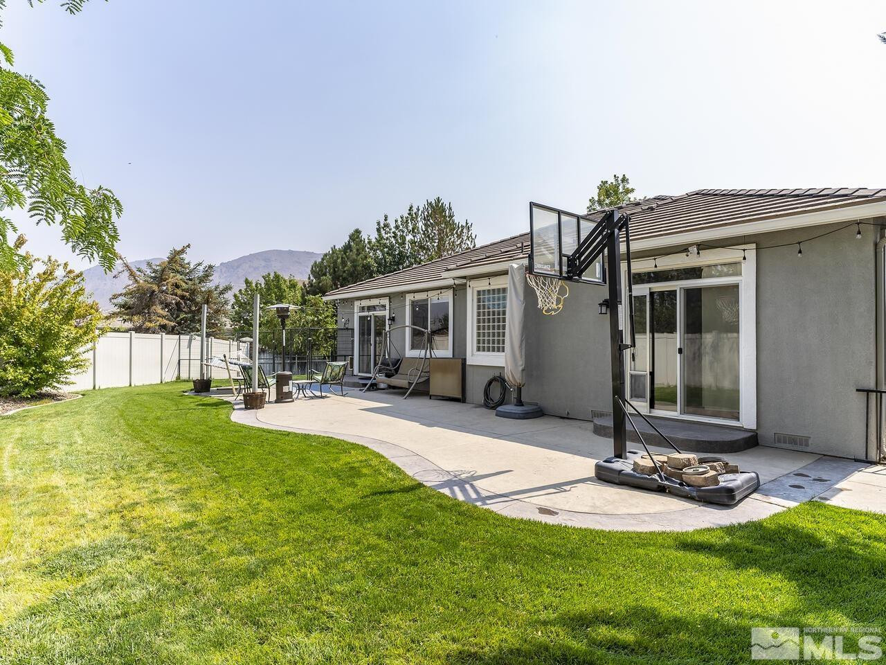 10805 Dancing Aspen Drive Reno, NV 89521 - Photo 22 of 25 a front view of house with yard and outdoor seating