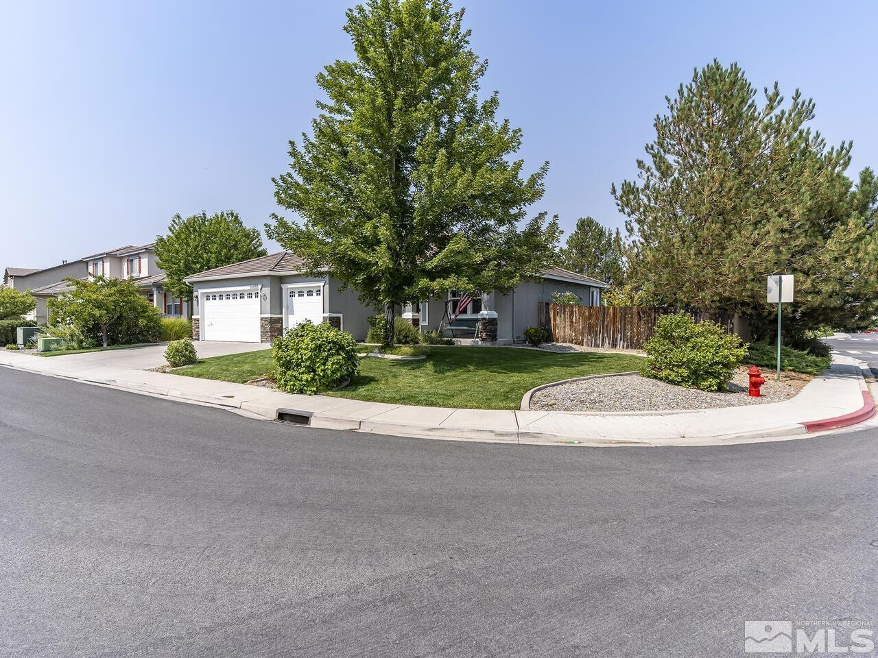 10805 Dancing Aspen Drive Reno, NV 89521 - Photo 3 of 25 a view of a house with a patio and a yard