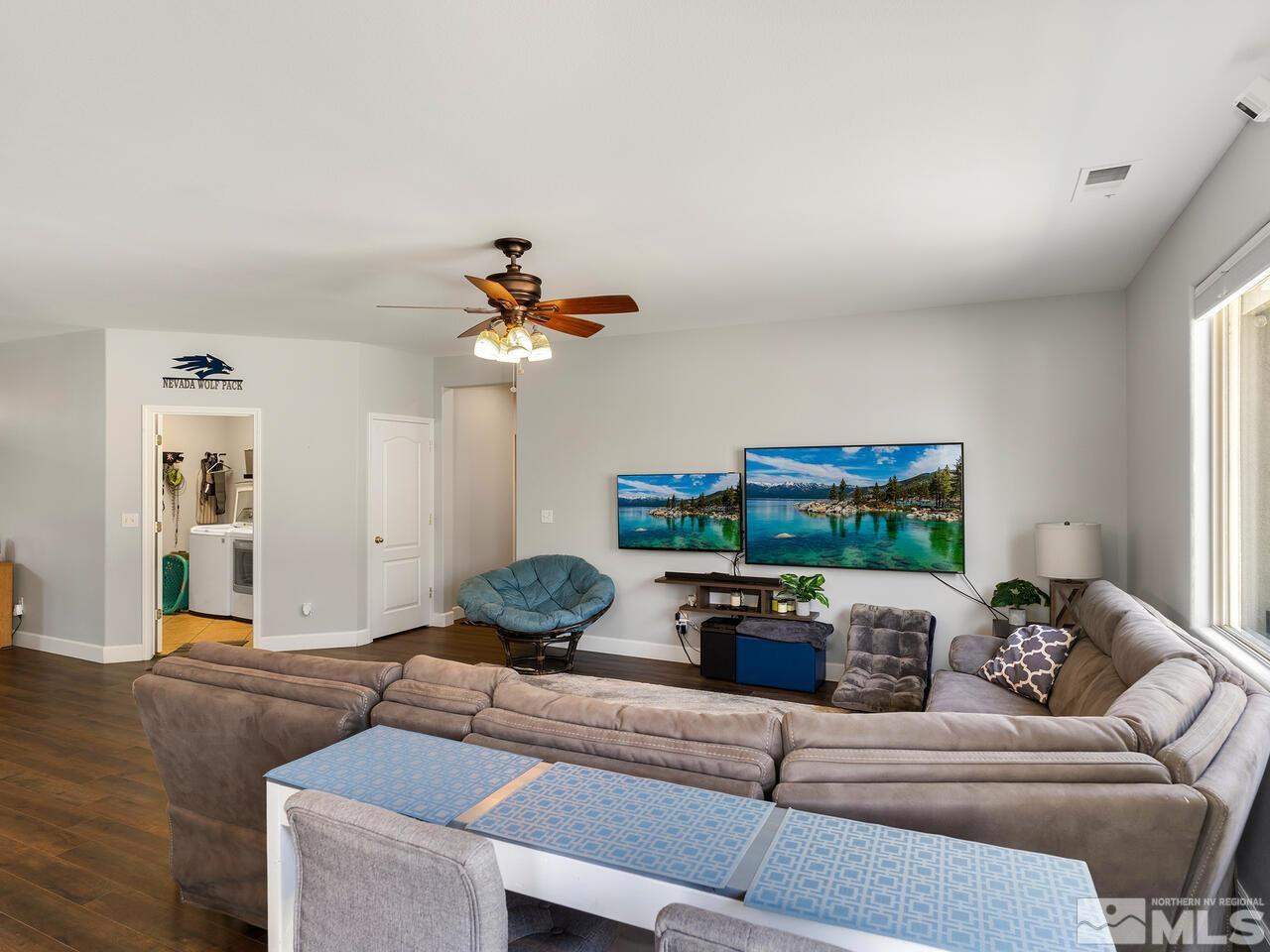 10805 Dancing Aspen Drive Reno, NV 89521 - Photo 9 of 25 a living room with furniture and a chandelier