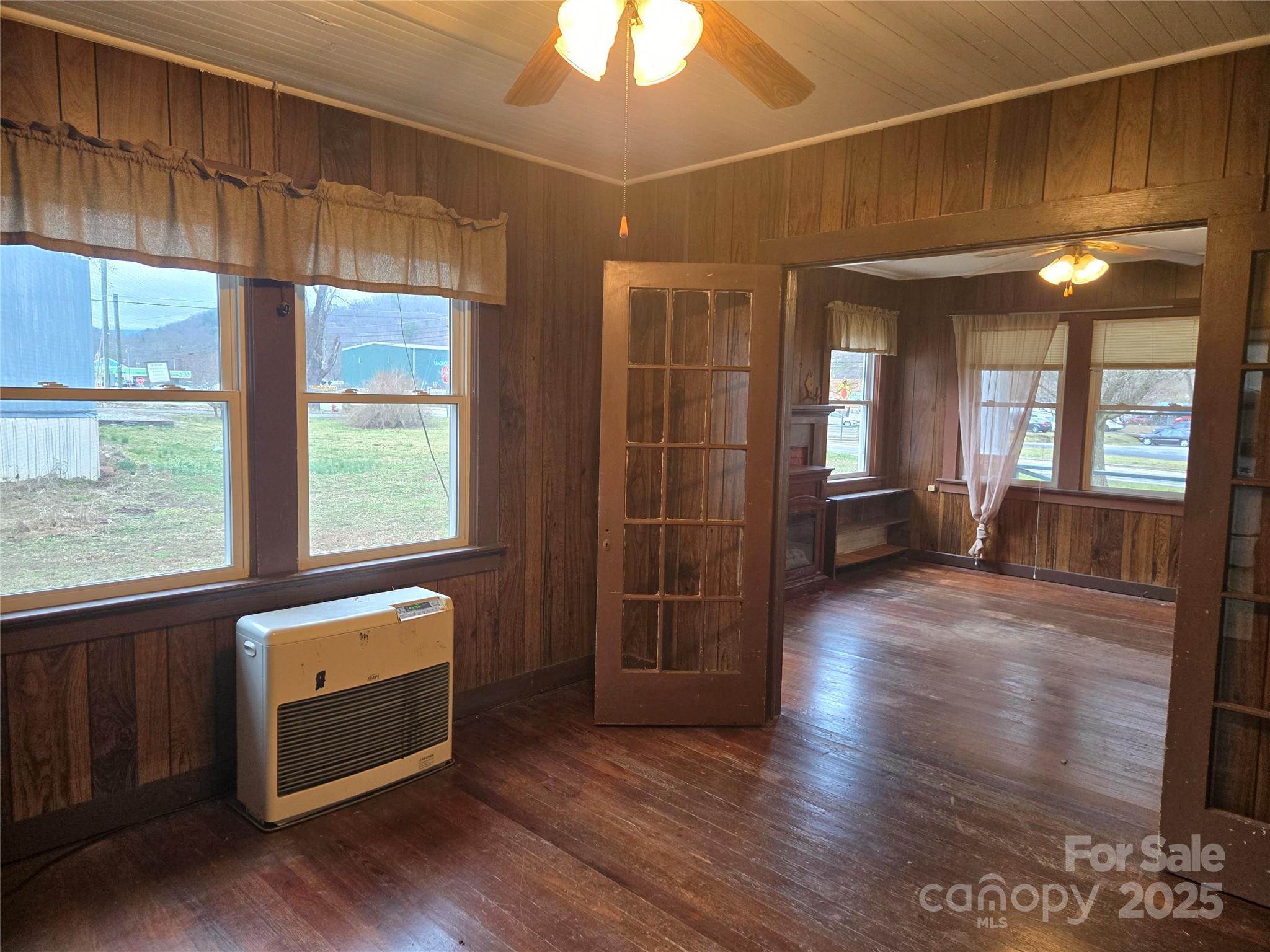 999 Chipper Curve Road Sylva, NC 28779 - Photo 11 of 17 a view of an empty room with window and wooden floor
