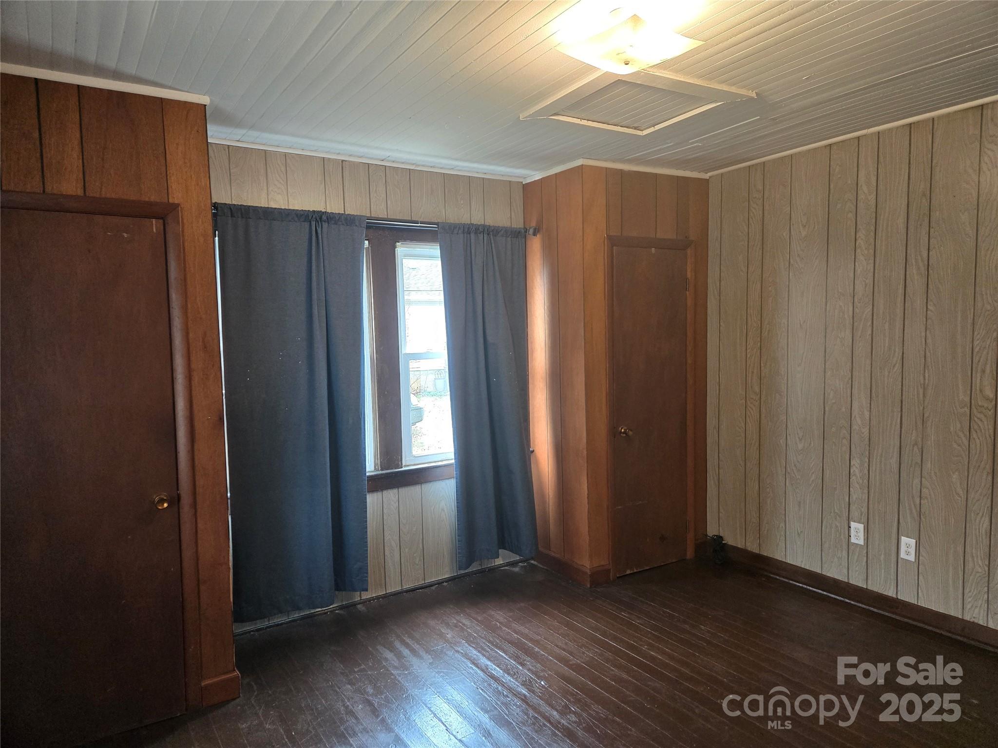 999 Chipper Curve Road Sylva, NC 28779 - Photo 13 of 17 an empty room with wooden floor and windows