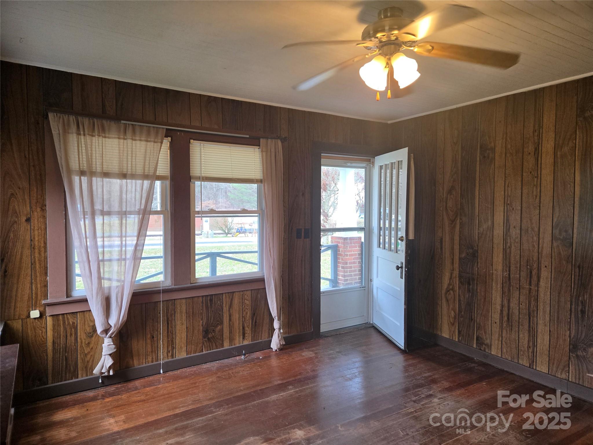 999 Chipper Curve Road Sylva, NC 28779 - Photo 6 of 17 a view of an empty room with a window and wooden floor
