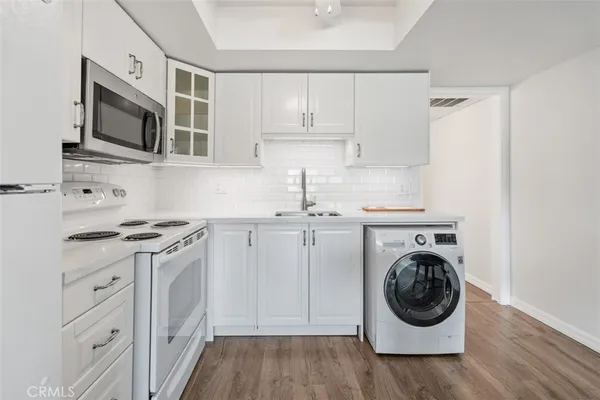 a kitchen with a stove top oven sink and cabinets