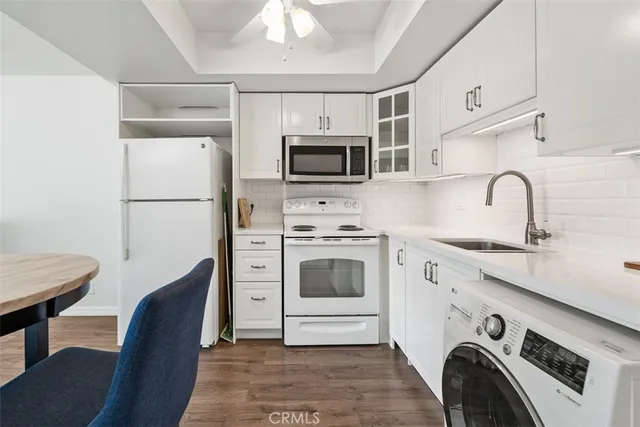 a kitchen with stainless steel appliances a stove a microwave and a refrigerator
