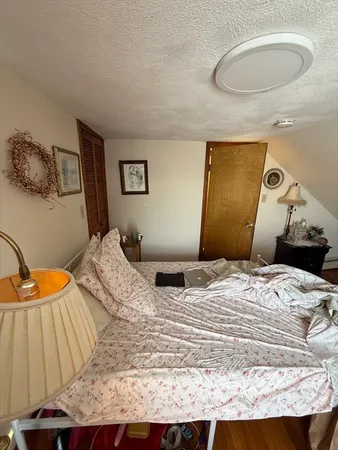 a bedroom with a bed and a lamp