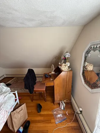 a living room with furniture and a mirror