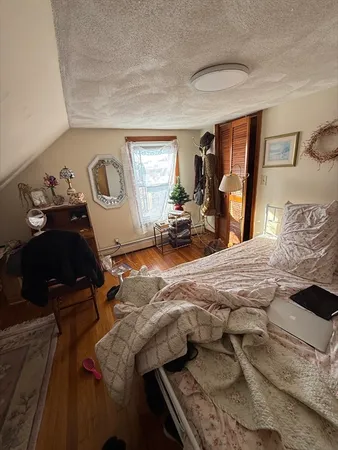 a bedroom with furniture and a window