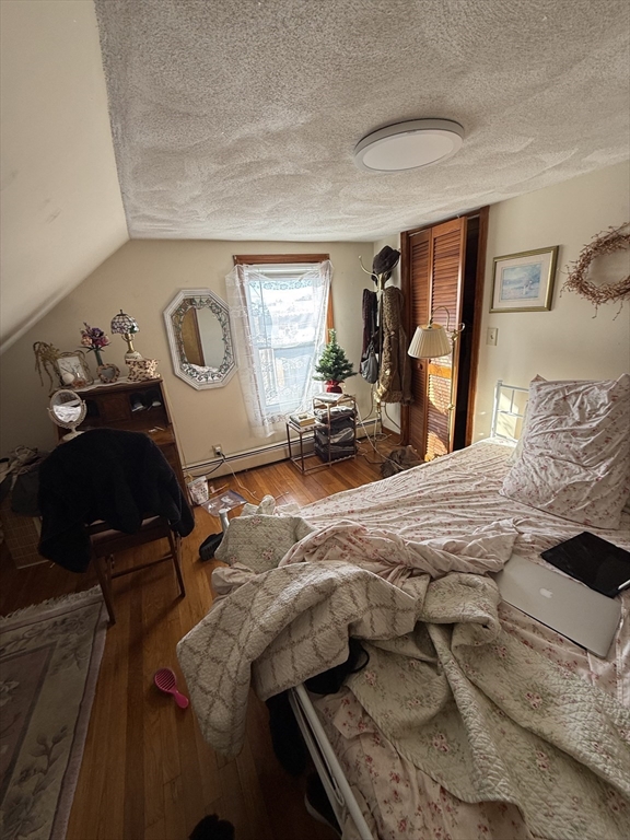 585 Somerville, Unit A1 Somerville, MA 02143 - Photo 14 of 19 a bedroom with furniture and a window