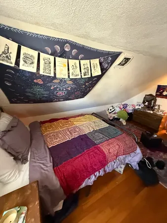 a bedroom with furniture and a window