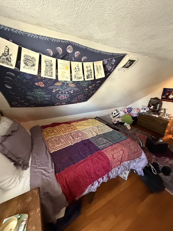 585 Somerville, Unit A1 Somerville, MA 02143 - Photo 17 of 19 a bed sitting in a bedroom next to a window